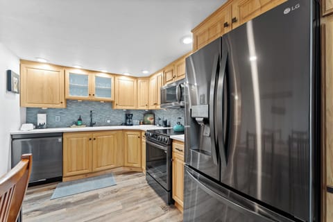 Full kitchen featuring all stainless steel appliances.