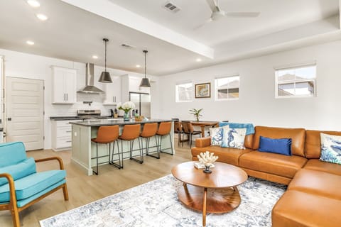 Open concept living area with counter seating plus a dining table and 4 chairs.