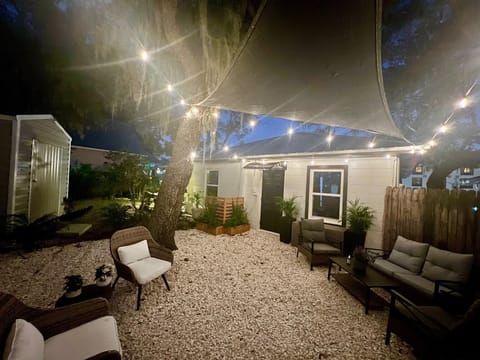 Backyard with shade sail, lights, patio for six, grill & citronella plants