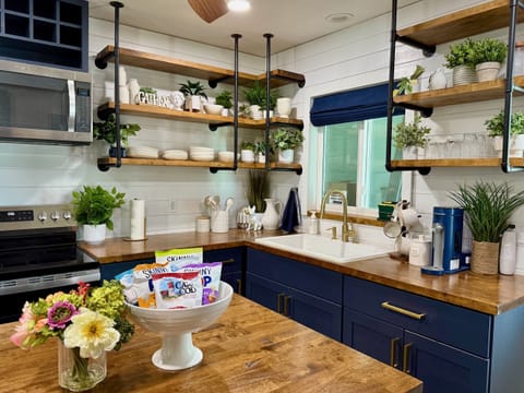 Fully equipped kitchen with stainless steel appliances, coffee station & more