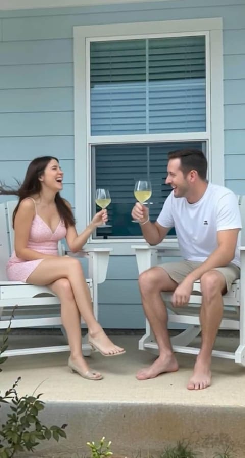 "Cheers to the perfect escape at The Sandy Rose: porch, wine glasses, and beach sounds, all yours"