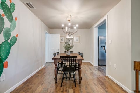 View from hallway to open dining area, blending rustic and modern styles