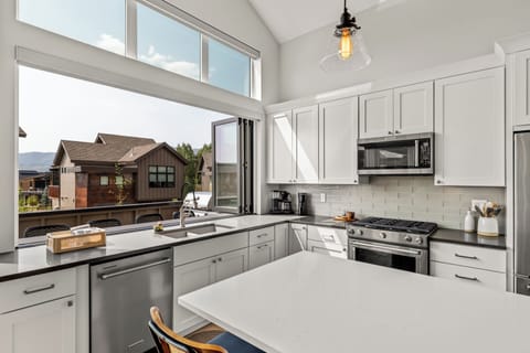 Bi-fold windows that open to the bar seating on the deck