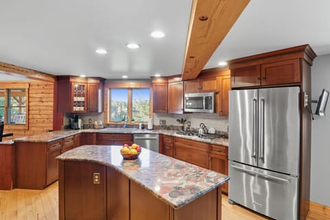 Open kitchen with island seating and panoramic views.