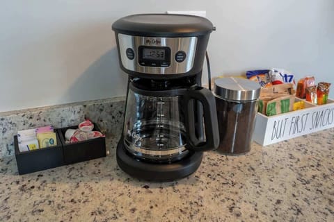 A designated space for brewing and enjoying coffee, designed for convenience and a cozy atmosphere.