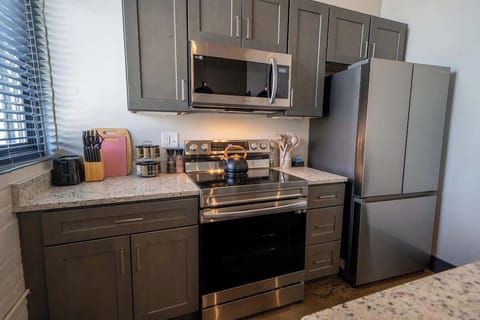 A functional and well-designed space for cooking and meal preparation, equipped with necessary appliances and tools.