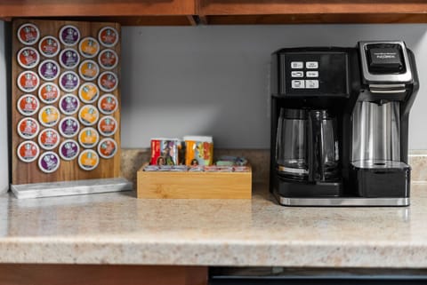Fully stocked coffee bar with coffee, tea, sugars, creamer and k-cups.