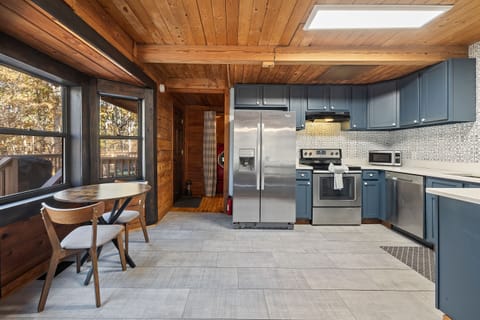 Kitchen open to dining, deck access