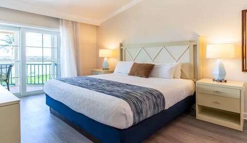 Unwind in a sunlit king bed after beach days.