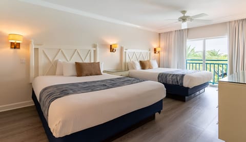 Stretch out in a serene room framed by tropical views.
