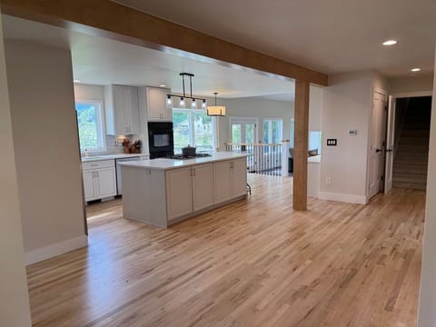 View from entry, stairs to separate queen bedroom, kitchen and family room