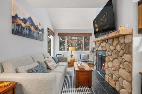 Living area with a Smart TV with cable, a double-sized sleeper sofa (all bedding provided) and a decorative fireplace (licensed for glow logs only please!)