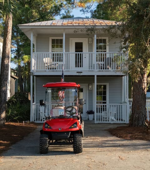 Welcome to Kingfish — charming two-story beach house with balconies and golf cart included.