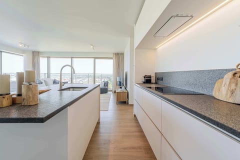 Streamlined kitchen with island counter for cooking and conversation.