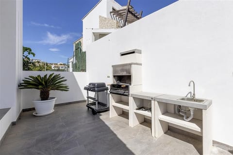 Barbecue area on the terrace with charcoal and gas barbecue