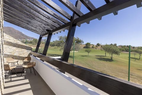 Terrace to the master bedroom with outdoor dining area and views to the golf courses and the sea