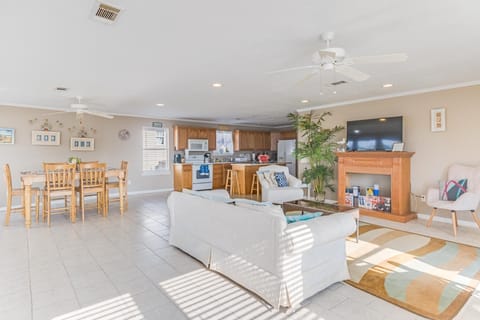 Inside, the open-concept living area combines comfort and style, featuring a modern kitchen and cozy seating for family gatherings.