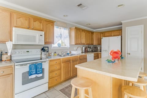 The well-equipped kitchen features ample cabinetry and modern appliances, making it a delightful space for meal preparation.