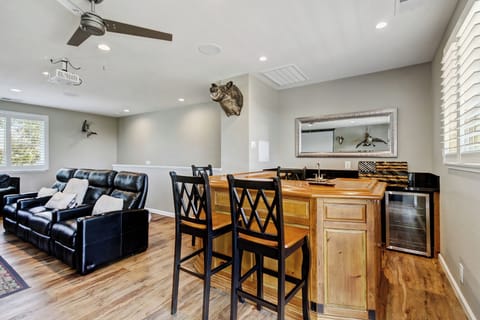 Wet bar equipped with sink, fridge and ice maker, seating for 4.