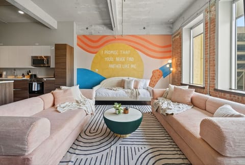 Lounge in Lyrics – blush sofas, big windows, and a mural declaring: “I promise that you’ll never find another like me.”