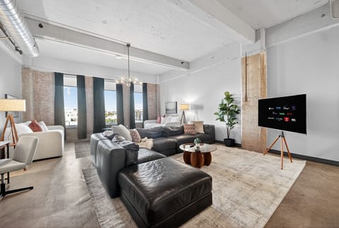 Gather & Relax – Oversized leather sectional and streaming-ready TV for ultimate comfort.