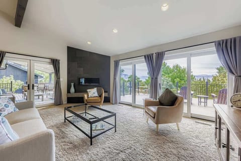 Inviting living room with a warm fireplace—perfect for relaxing after a long day. Access to the Deck from this Room. 