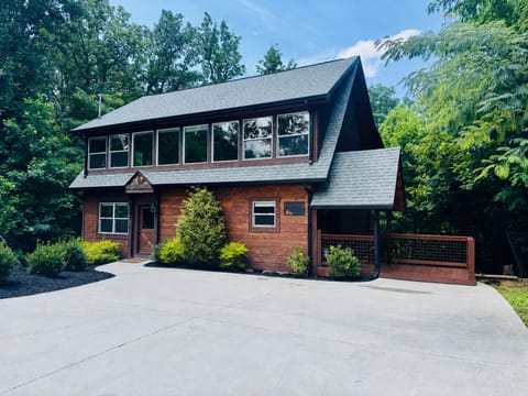 Private woodland cabin with large driveway and inviting covered deck