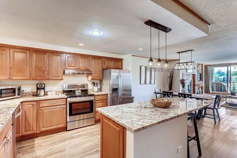 Cook and entertain in this gourmet kitchen featuring sleek granite countertops and modern appliances, perfect for creating cherished meals with loved ones.