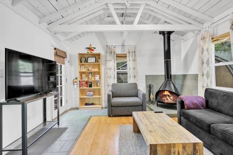 Relax in this cozy cabin, enjoy the sofa bed, natural light, and warm vibes.