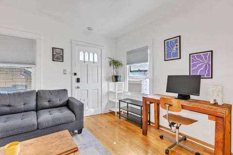 Chic living room with sofa and workspace, ideal for relaxing or getting work done.
