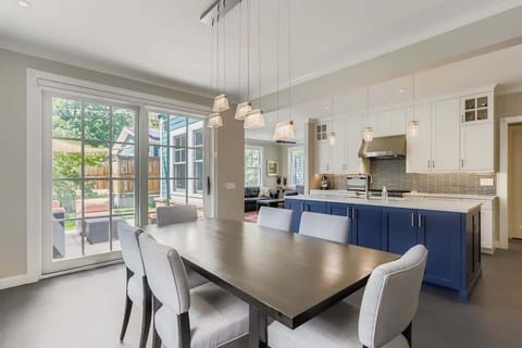 A dining table seamlessly integrated into the open kitchen, perfect for casual meals, entertaining, or enjoying a home-cooked dinner in a bright, social space.