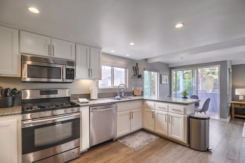 Second Floor: kitchen with stainless steel appliances, dining area, and balcony views.