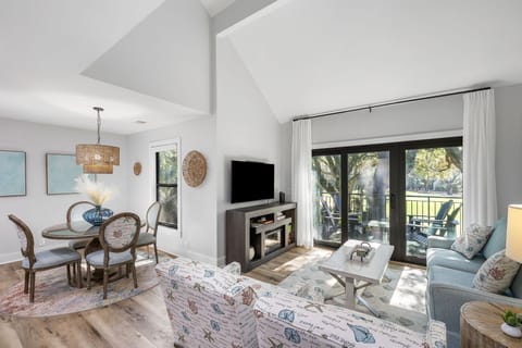 Enjoy an open-concept living and dining area with high ceilings and plenty of natural light. Large sliding glass doors lead directly to your private balcony.