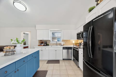 Kitchen: Bright blue accents and modern amenities await your culinary adventures!
