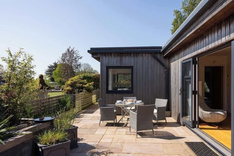 A serene outdoor space, complete with furnishings, perfect for enjoying a meal or simply unwinding.