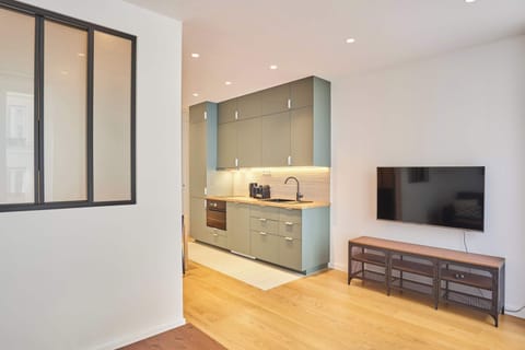 Salon avec canapé lit, table basse, smart TV