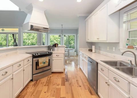 A chef’s kitchen stocked with everything from wine glasses to a dishwasher.