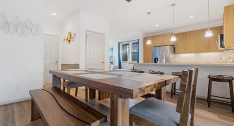 Large wooden dining table, perfect for family meals and group celebrations.