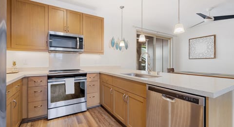 Modern kitchen with stainless appliances and everything needed for home-cooked meals.