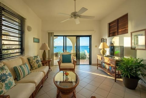 Lounge to ocean views as sunlight fills the room.