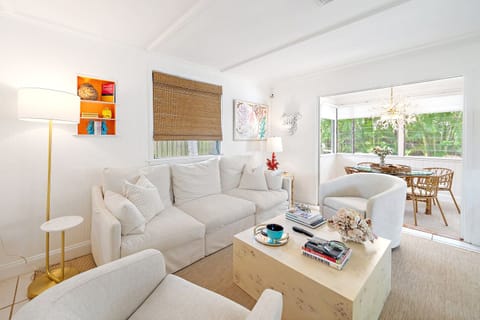 Cozy main living room, open and airy with access to dining room with views of the outdoor private patio and seating area.