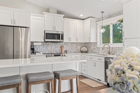 Kitchen is equipped with pots/pans, plates, silverware, serving dishes, glasses