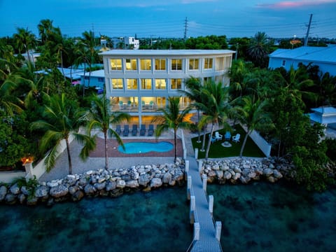 Sunset view of the pool and home (Boat lift is not for guest use)