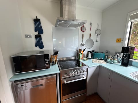 Classic Kiwi kitchen equipped with modern essentials: Espresso machine