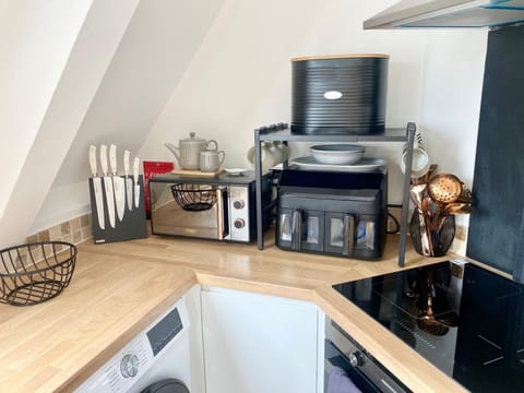Thoughtfully stocked kitchen corner featuring an air fryer, toaster oven, and all the essentials — perfect for home-style cooking during your stay.