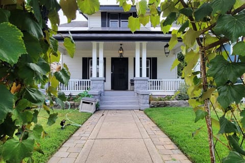 Front of the house with a fully fenced yard and porch