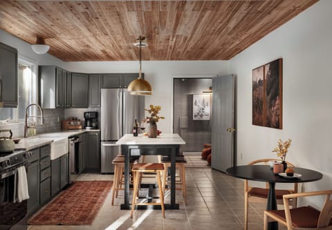 Elegant, fully stocked kitchen with granite, brass accents, and new appliances.