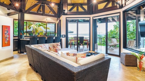 Living room with view of ocean and open kitchen with breakfast bar