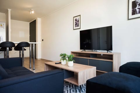 Relax in this cozy living area with a large TV and stylish decor, perfect for unwinding after a day of exploring.