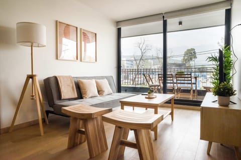 Relax in this stylish living room with balcony access, perfect for soaking in the views and unwinding in comfort.